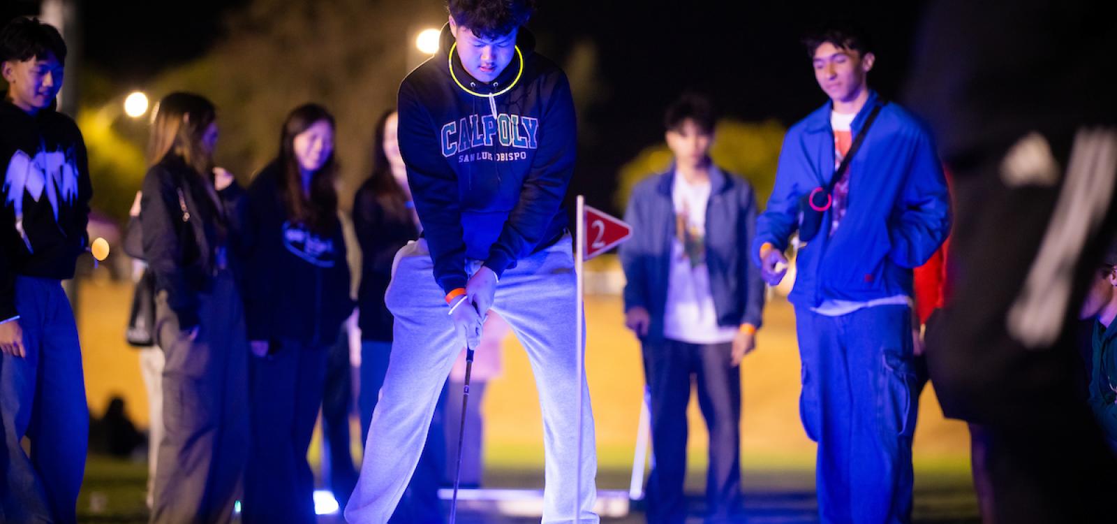 Students play mini golf during the WOW carnival.