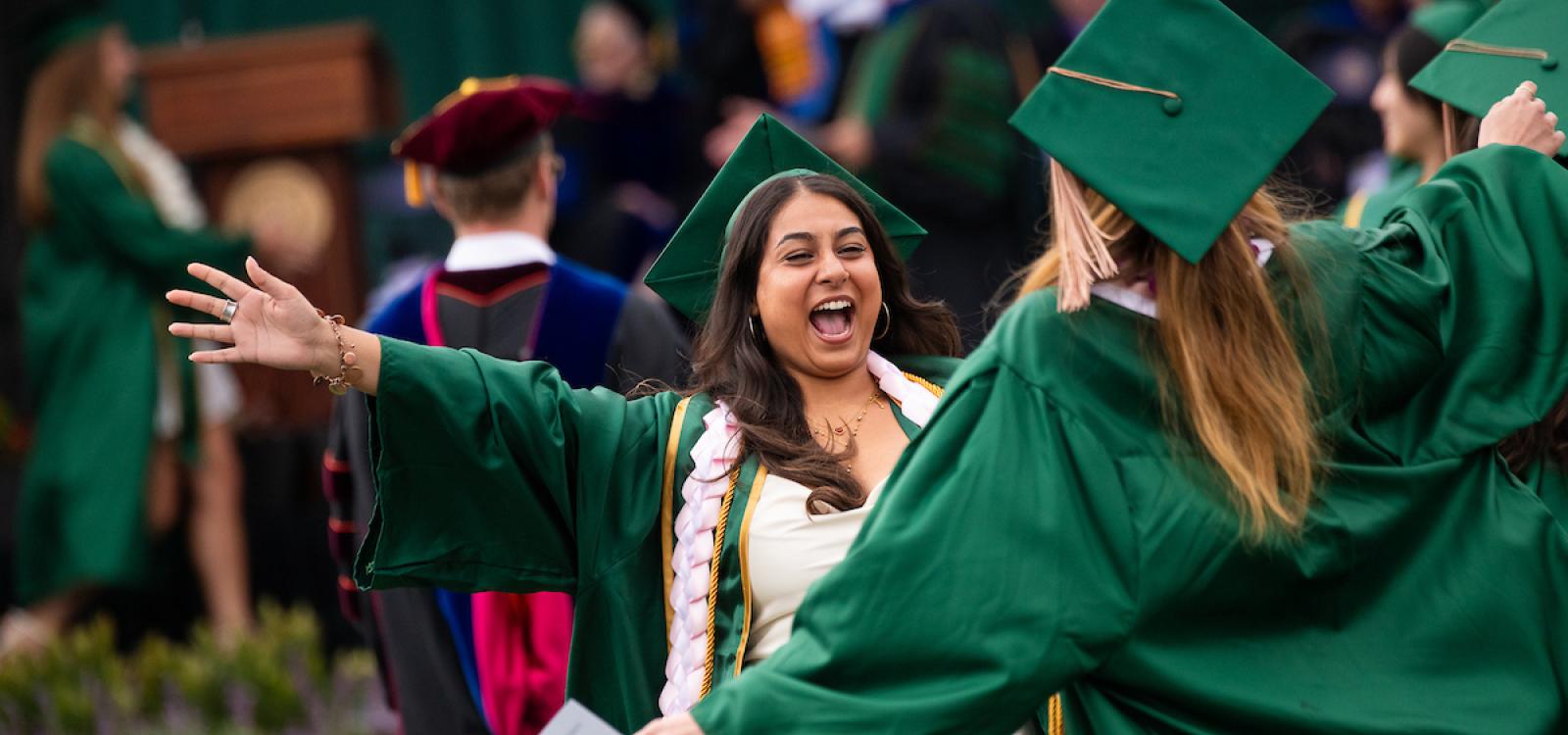 Graduates go in for a hug at the Orfalea College of Business commencement.