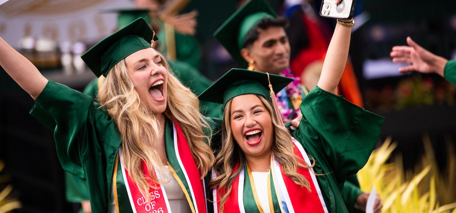 Two Orfalea College of Business graduates share a happy moment.