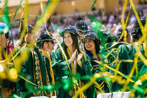 Graduating students celebrate with streamers at Cal Poly Commencement.