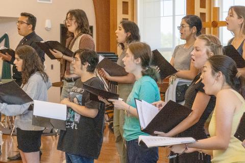 Music camp attendees rehearse their vocals.