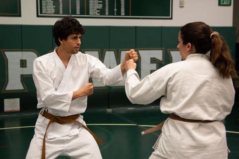 Two individuals spar in a martial art.