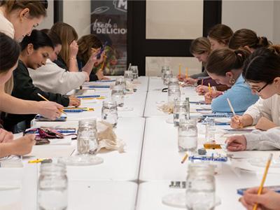 Students painting ceramics in the ASI Craft Center.