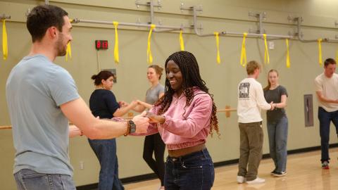 Students participating in a Salsa/Bachata workshop.