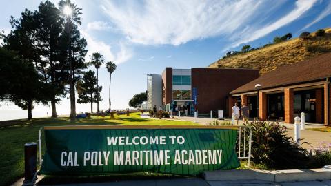 A sign that says "Welcome to Cal Poly Maritime Academy" at the center on campus.