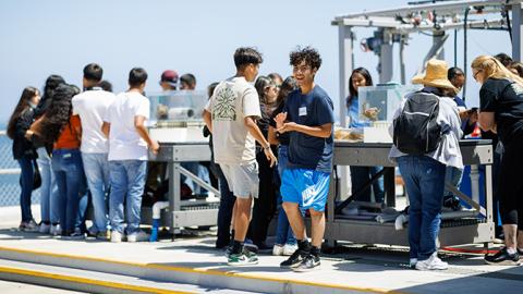 Young people taking a tour of the Cal Poly Pier.