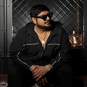 A headshot of Rene Vaca wearing sunglasses with black zip-up jacket.