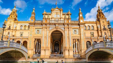 A photo of people riding gondolas in Seville’s Plaza de España.