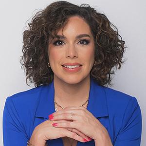 A headshot of Alba Franco-Cancél in a blue blouse.