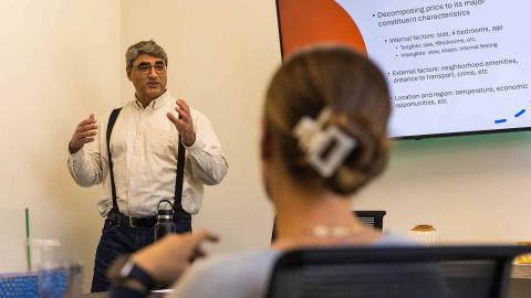 Finance Professor Hamed Ghoddusi lecturing in the classroom.