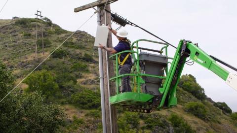 A utility employee working in Poly Canyon.