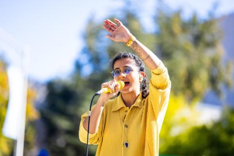 A woman speaks into a microphone.