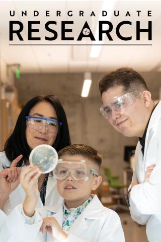 The cover of Undergraduate Research magazine with an image of two adult scientists and a child conducting an experiment