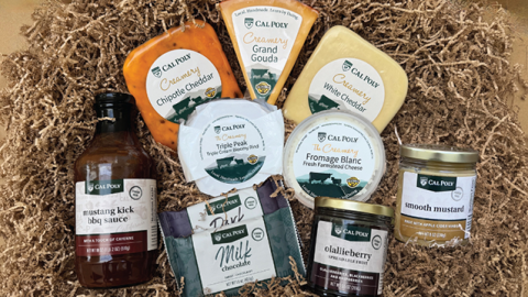An assortment of Cal Poly cheeses, jams and barbecue sauce in a gift box.