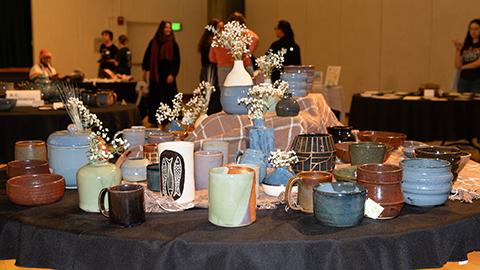 A closeup of a table with pottery on it at a previous Makers Market.