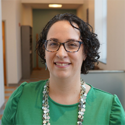 A headshot of Bayley Marquez in a green shirt.