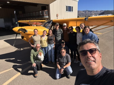 Aerospace engineering professor Paulo Iscold taking a selfie with his students in front of the Carbon Cub UL. 