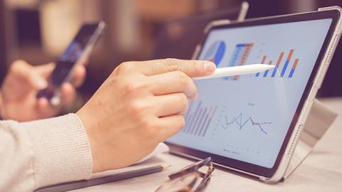 A closeup of a person using a computer to provide statistics consulting.