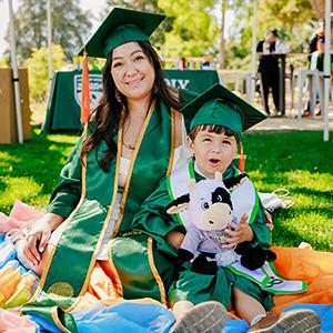 Cal Poly alumna Vanessa Vera, pictured with her child, at the June commencement ceremonies.