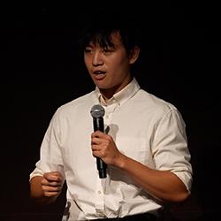 Carter Lim giving his elevator pitch on stage.
