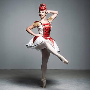 A ballerina dressed as a toy solider. 