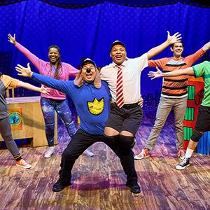 The cast of "Dog Man: The Musical" performing on stage.