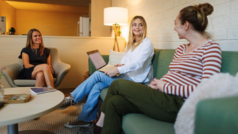 Bri Frickman Miller, now a Guardian Scholars intern, meets with program coordinators Shayna Citrenbaum and Lea Scott to talk about upcoming events.