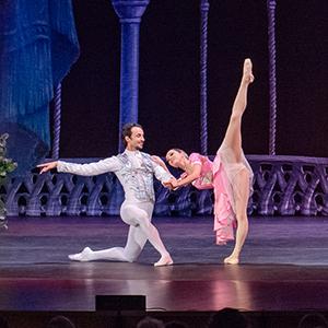 Two lead ballet dancers performing "Snow White" on stage.