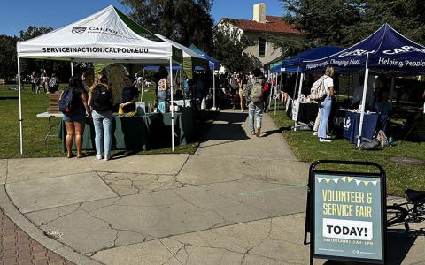 People standing at pop-up booths during a past Volunteer and Service Fair on Dexter Lawn.