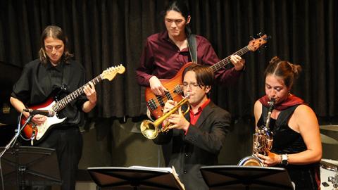 Jazz Combos students playing instruments on stage.