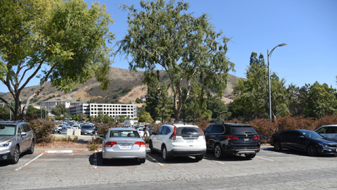 An image of cars parked in a parking lot on campus.