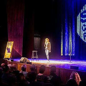 A standup comic performing on stage.