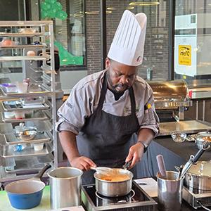 Chef Arthur Dulin preparing a dish in the kitchen.