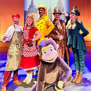 Curious George with the other cast members of “Curious George: The Golden Meatball” on stage.
