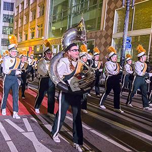 Mustang Marching Band performing in a parade.