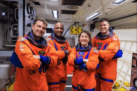 Artemis II NASA astronauts (left to right) Reid Wiseman, Victor Glover and Christina Koch and CSA (Canadian Space Agency) astronaut Jeremy Hansen wearing orange suits.