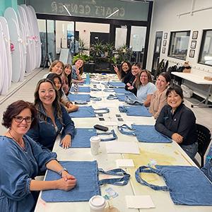 Faculty and staff decorating denim at a past event in the Craft Center.