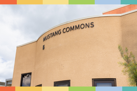 A graphic with an image of the exterior of Mustang Commons and rainbow lines on the top and bottom.