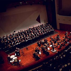 SLO Master Chorale and Orchestra performing on stage.