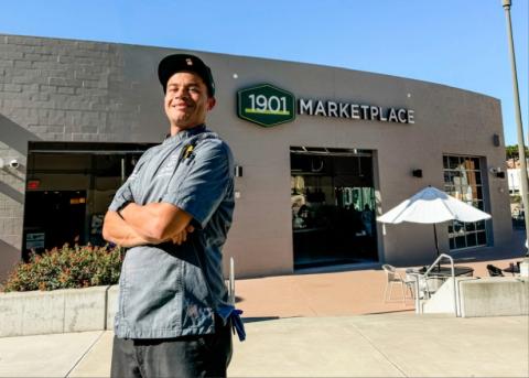 Chef Jones standing in front of the 1901 Marketplace on the Cal Poly campus.