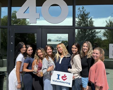 Eight Cal Poly students stand outside 40 Prado Homeless Services.