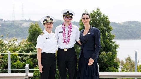 Left to right: Capt. Samar Bannister, Summer Sea Term Corps Cmdr. Jenny Scott and Capt. Kate McCue standing together in front of the bay.