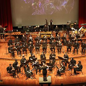 Members of the Cal Poly Wind Bands performing on stage.