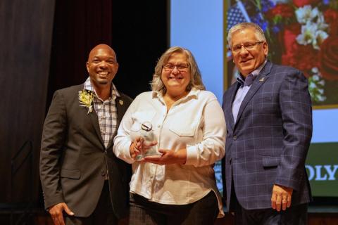 Linda Ortiz accepting an award from Cal Poly leadership at Convocation.