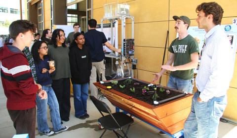 Cal Poly students show a teacher how their new sensory tools work.