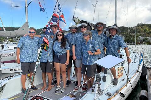 The Cal Poly Maritime Academy Sailing Team, coach and crew aboard their vessel.