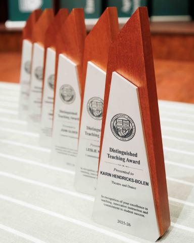 Cal Poly Distinguished Teaching Awards lined up on a table at a past Convocation.