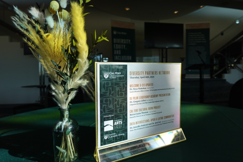 A framed Diversity Partners Network agenda and centerpiece inside the Performing Arts Center lobby.