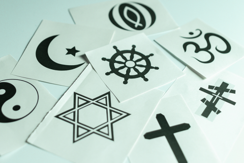 A collection of Post-its with different religious symbols on them.