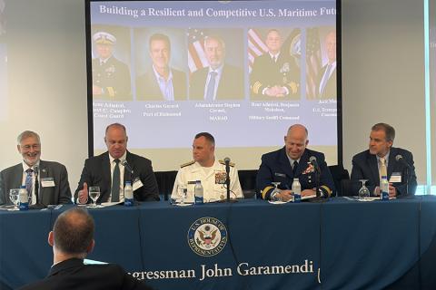 Maritime leaders sitting at a table during a panel discussion.